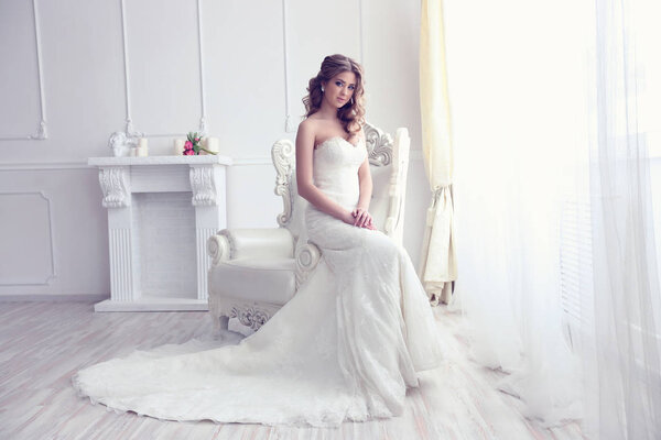 Young bride in antique armchair