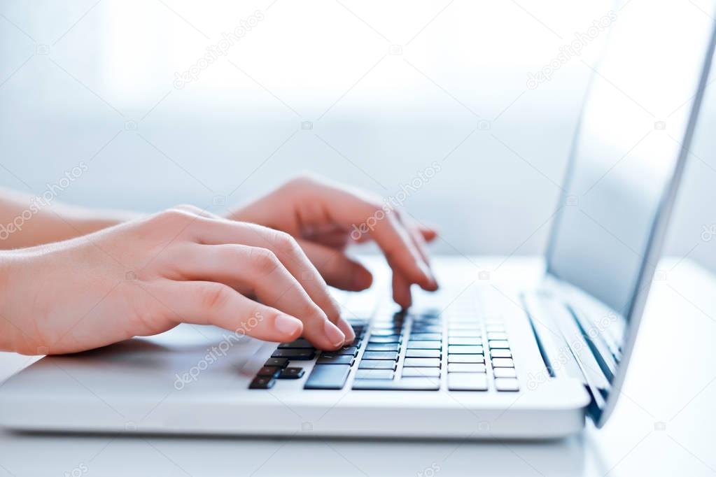 Woman hands using laptop