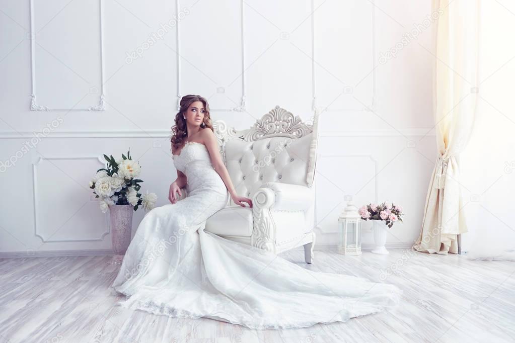 bride sitting in antique armchair