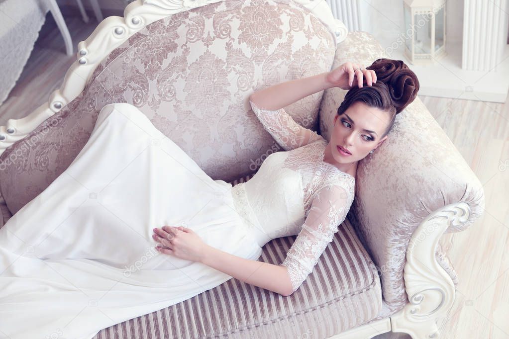 bride lying in antique couch