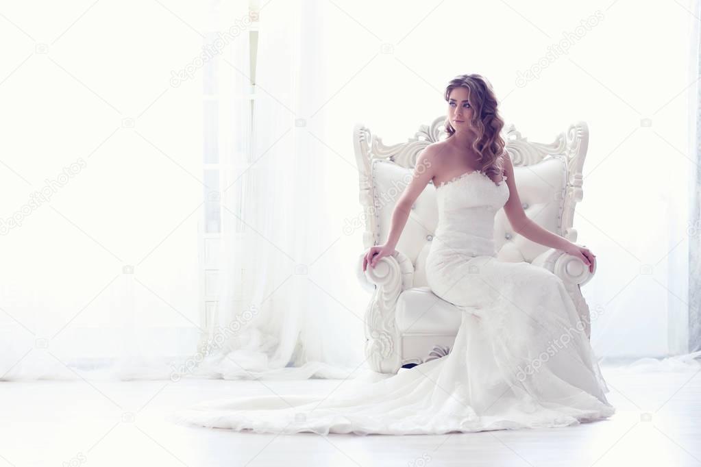 Young bride in antique armchair