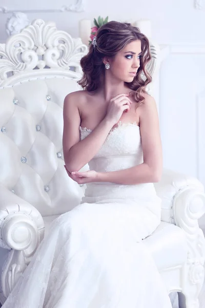 bride sitting in antique armchair