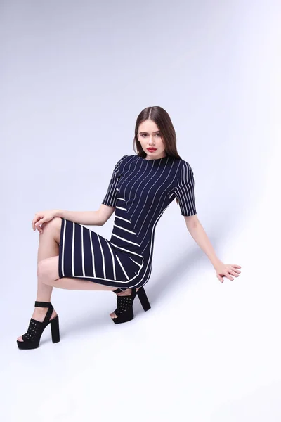 Young woman in striped dress — Stock Photo, Image