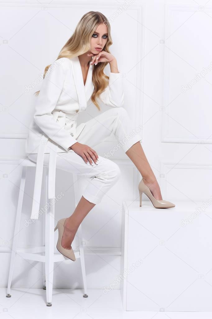blond woman in white suit