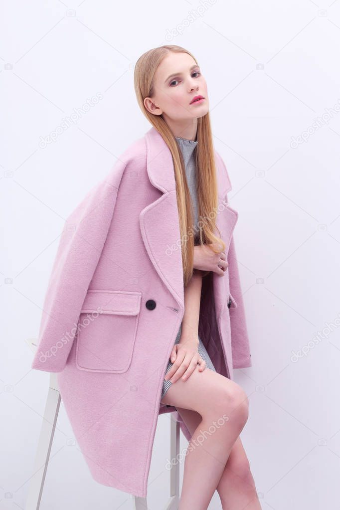 Blond woman in pink coat