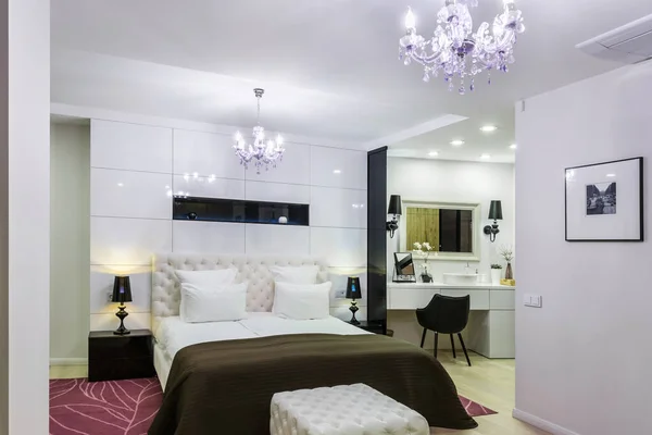 Minsk, Belarus - September, 2019: Interior of the modern luxure vip bedroom with big double bed in studio apartments in white light color style — Stock Fotó