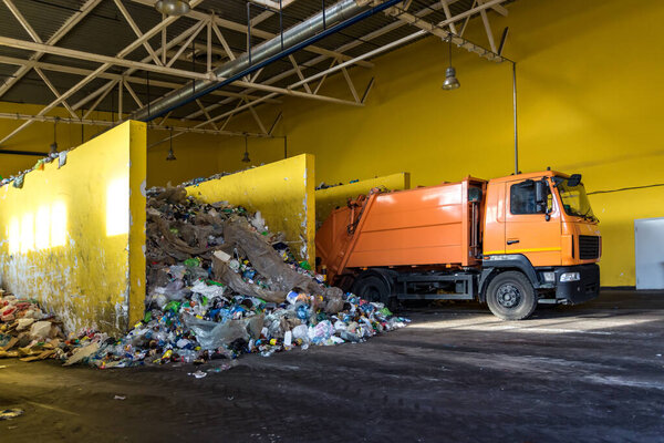 truck throws garbage at sorting modern waste recycling processing plant. Separate and sorting garbage collection. Recycling and storage of waste for further disposal. 