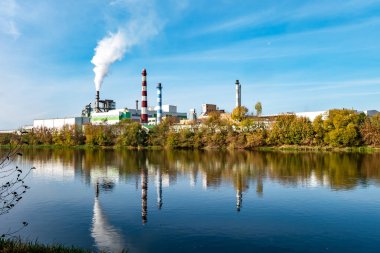 Nehir kenarındaki kereste fabrikası boruları. Hava kirliliği konsepti. Endüstriyel arazi çevresel kirlilik termik enerji santralinin atıkları