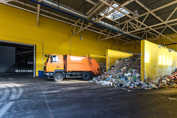 truck throws garbage at sorting modern waste recycling processing plant. Separate and sorting garbage collection. Recycling and storage of waste for further disposal. 