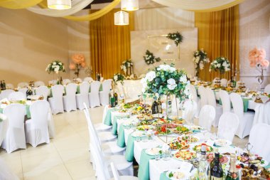 Grodno, Belarus - Mayıs 2019: Elit bir restoranda güzel çiçeklerle süslenmiş düğün yemeği masasının manzarası.