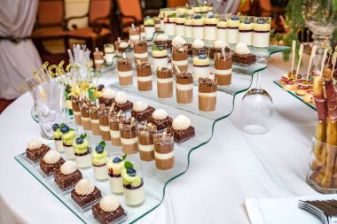 Yemek servisi. Tesis dışı yemek. Çeşitli tatlı çikolatalarla açık büfe masası.