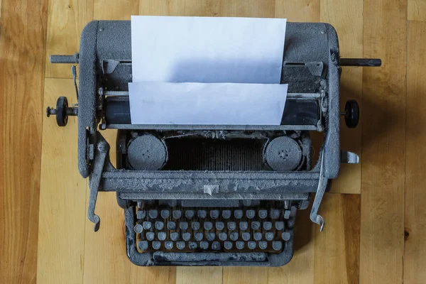 Vecchia macchina da scrivere vintage ricoperta di polvere con foglio di carta bianca — Foto Stock