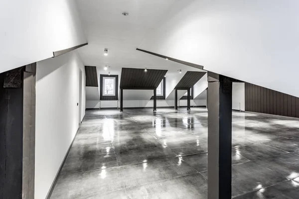 Empty unfurnished loft mansard room interior with wooden columns and wet concrete floor on roof level in black and whote style color — Stock Photo, Image