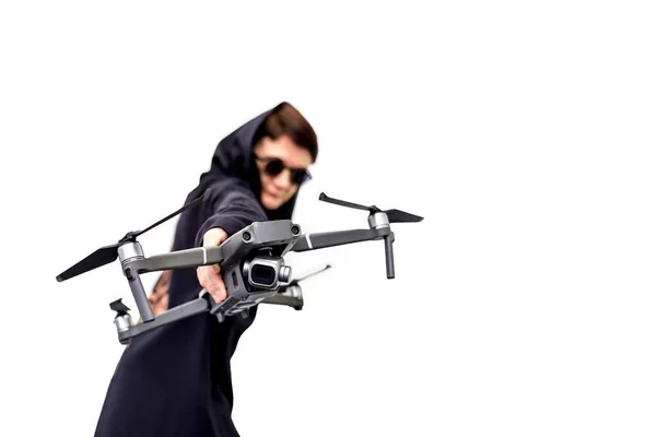 female spy in black clothes and round glasses with a drone isola