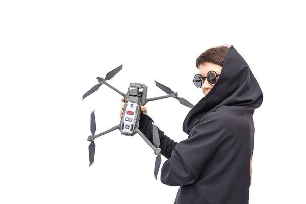 female spy in black clothes and round glasses with a drone isola