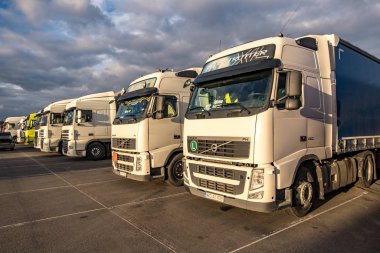 GRODNO, BELARUS -  JANUARY 2020: Trucks in a row with containers in the parking lot. Logistic and Transport concept