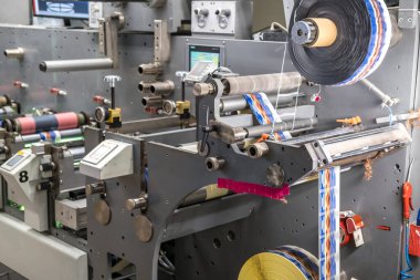 MINSK, BELARUS - JANUARY 2020: Rows of Large offset printing press. moving polymer label conveyor typography facility and flexographic printing