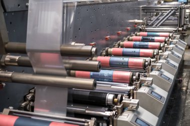 MINSK, BELARUS - JANUARY 2020: Rows of Large offset printing press. moving polymer label conveyor typography facility and flexographic printing