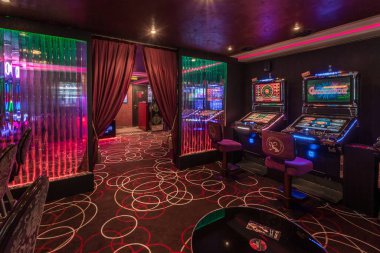 LAS VEGAS, USA - MAY, 2017: interior of elite luxury vip casino with rows of gambling slots machine in cherry red color style
