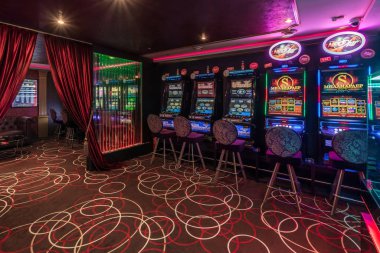 LAS VEGAS, USA - MAY, 2017: interior of elite luxury vip casino with rows of gambling slots machine in cherry red color style