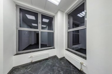 big windows in empty unfurnished room interior in white style co