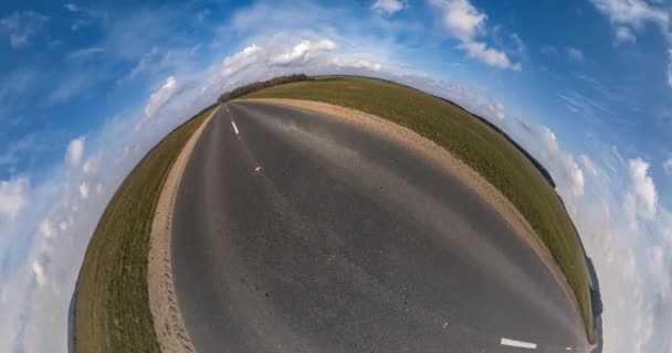 小行星的变化具有空间曲率 天气晴朗 多云的天气晴朗地区 沥青路面上的全飞行全景在田野间的旋转 扭转和旋转 — 图库视频影像