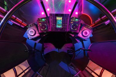 MINSK, BELARUS - MAY 2012: interior of stylish night disco club with neon blue violet light, disco mirror ball and bright floodlight.