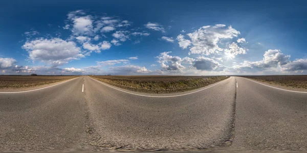 Full spherical seamless panorama 360 degrees angle view on no traffic asphalt road among fields in sunny day with cloudy sky. 360 panorama in equirectangular projection, VR AR content