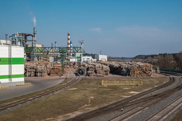 pipes of woodworking enterprise plant sawmill near river. Air pollution concept. Industrial landscape environmental pollution waste of thermal power plant