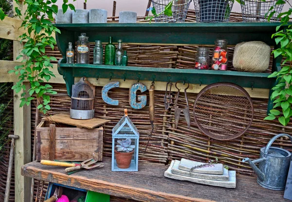 Interior of a garden potting shed with plants, tools, work bench