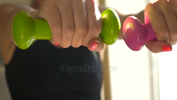 Girl makes exercise with dumbell — Stock Video