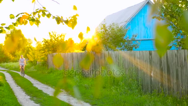 Young woman rides bicycle in summertime — Stock Video