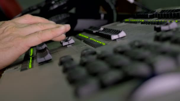 Hand of the sound producer on the mixing console — Stock Video