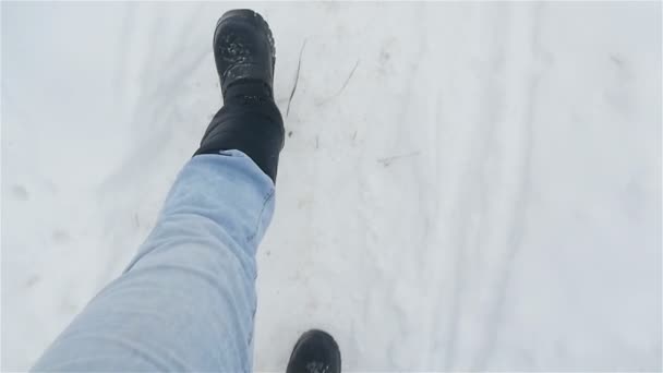 A man in black boots is walking in the white snow. Close-up of legs. Slow motion — Stock Footage A man in black boots is walking in the white snow. Close-up of legs. Slow motion Stock Video