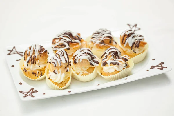 Cream puff cake with filling and chocolate icing.