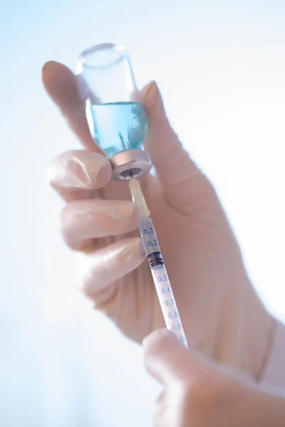 Hands with vaccine bottle — Stock Photo, Image