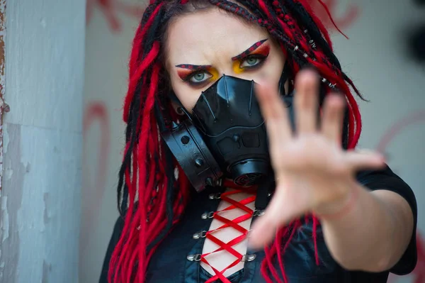 Post-apocalyptic woman with weapon outdoors.Woman cyberpunk. Neon. Future. Gaming.