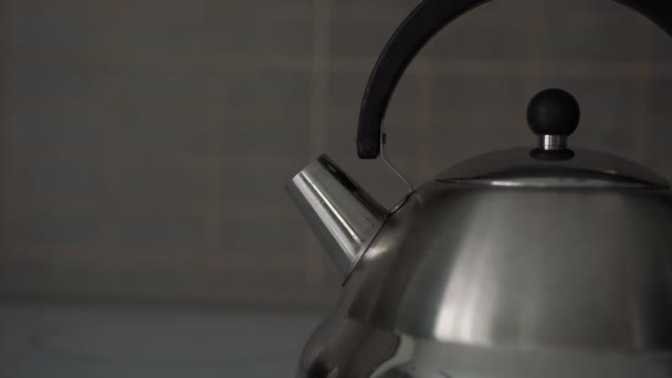 Man takes metal kettle away and switches off induction stove — Stock Video