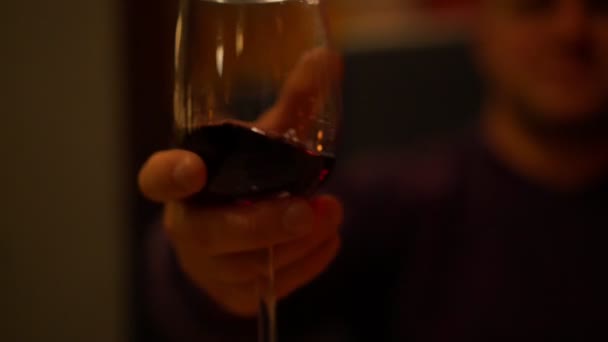 Man wearing violet sweatshirt splashes delicious red wine — Stock Video