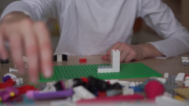 Hardwerkende schoolmeisje creëert mooie toren met behulp van lego — Stockvideo