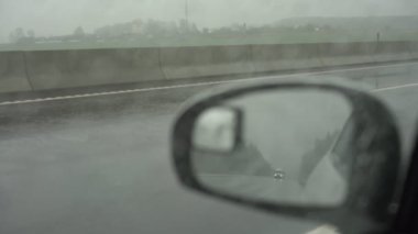 autos drive along wide road with towing cars and side mirror