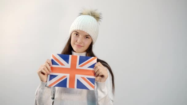 Şapkalı kız stüdyoda Birleşik Krallık bayrağını taşıyor. — Stok video