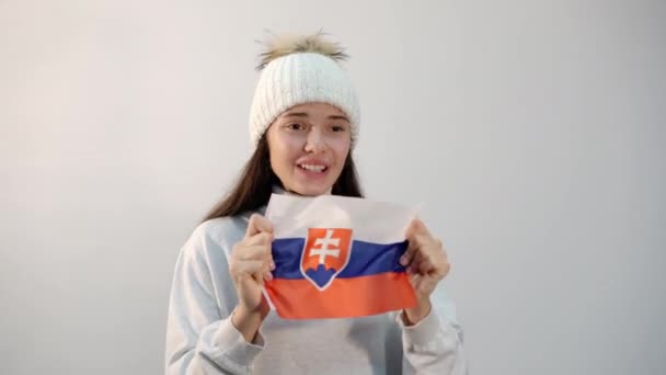 Cheerful girl with flag of Slovakia on light background — Stock Video