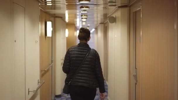 Young woman walks along Helsinki Tallinn ferry corridor — Stock Video