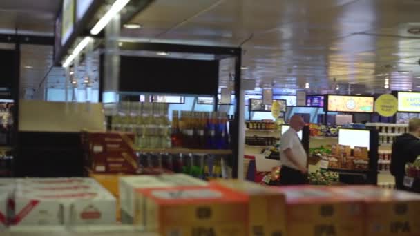 People choose products in large ferry duty free shop — Stock Video