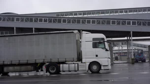 Грузовики проезжают по дороге Таллиннского порта против строительства — стоковое видео