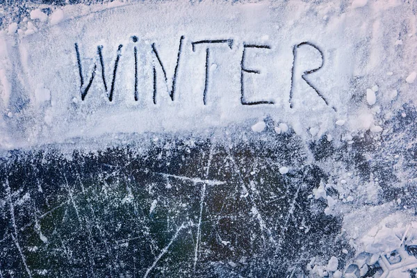 WINTER inscription at ice background