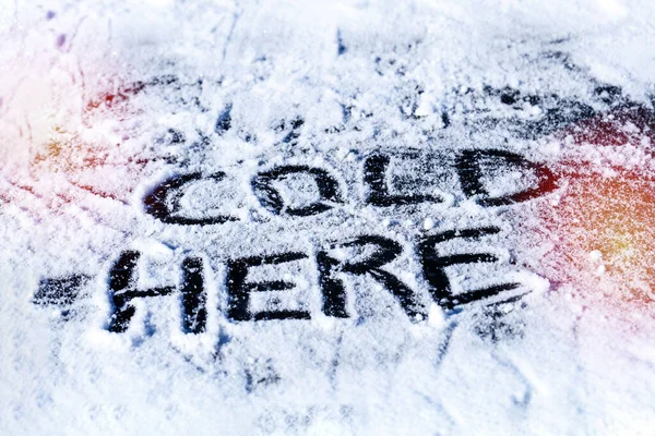 Cold here inscription on ice — Stock Photo, Image