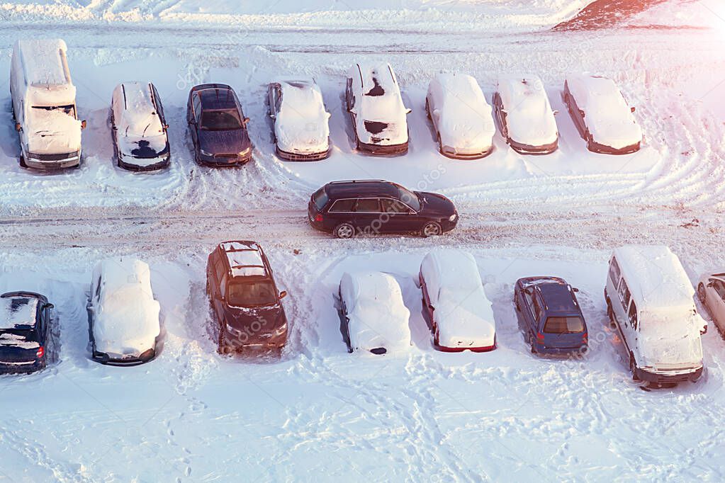 Cars in snow in parking lot