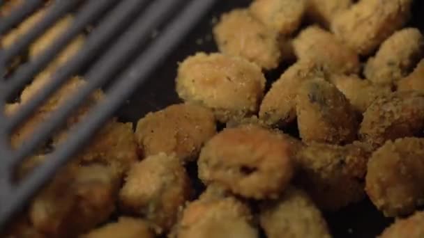 Person prepares chicken nuggets stirring with spatula close — 비디오